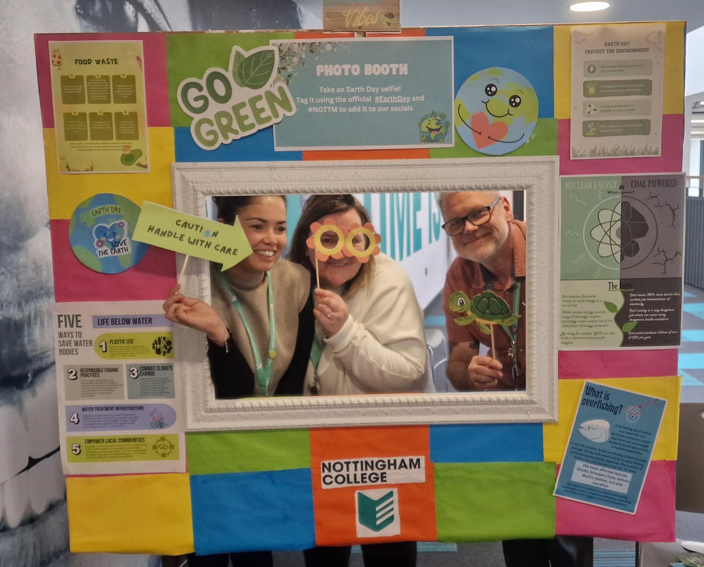 Staff looking through a photo booth.