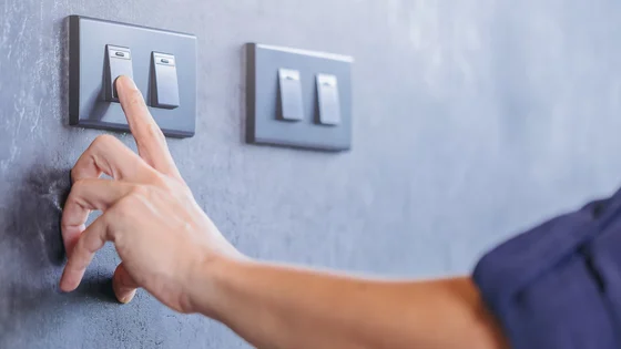 A person turning a switch on