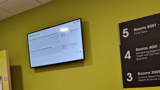 A photography of a digital screen on the wall at the City Hub.