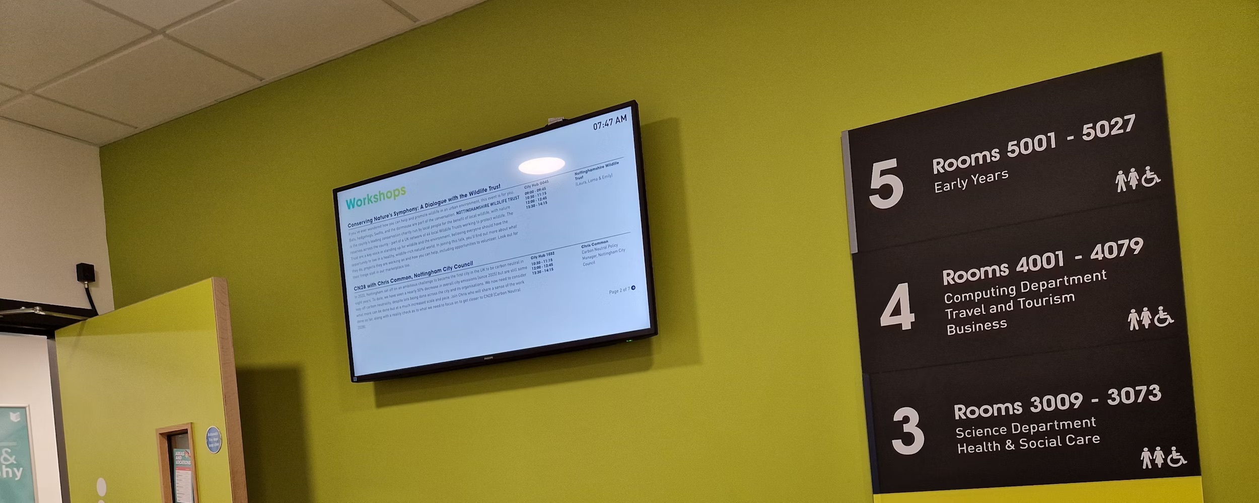 A photography of a digital screen on the wall at the City Hub.