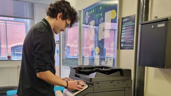 A member of staff using a printer