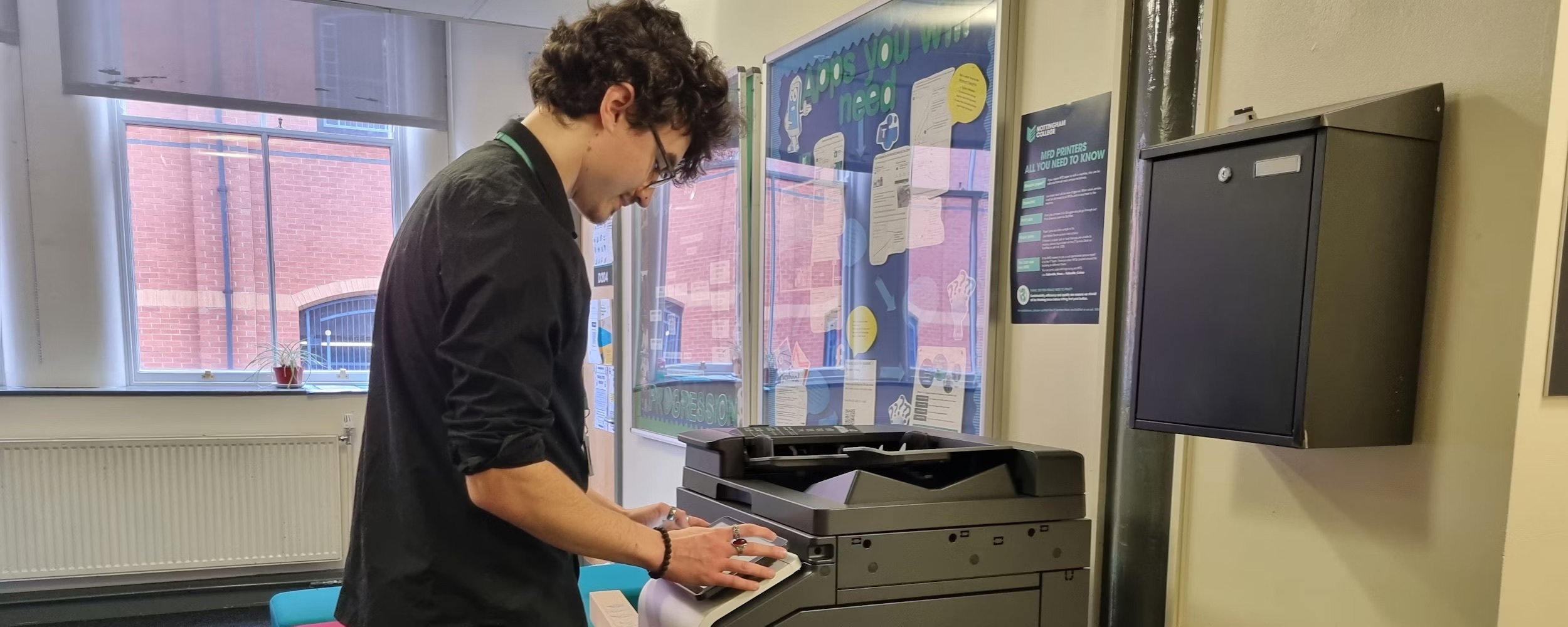 A member of staff using a printer