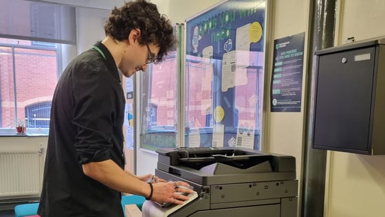 A member of staff using a printer