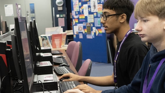 Students working in a classroom with desktop computers