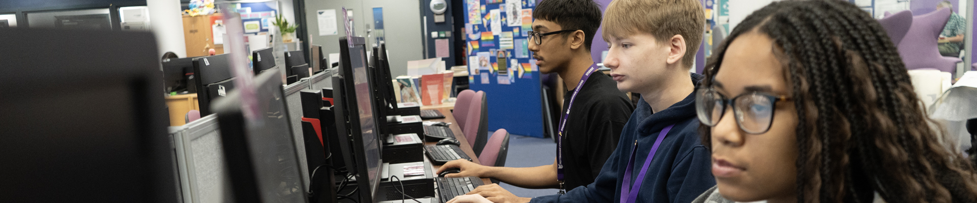Students working in a classroom with desktop computers