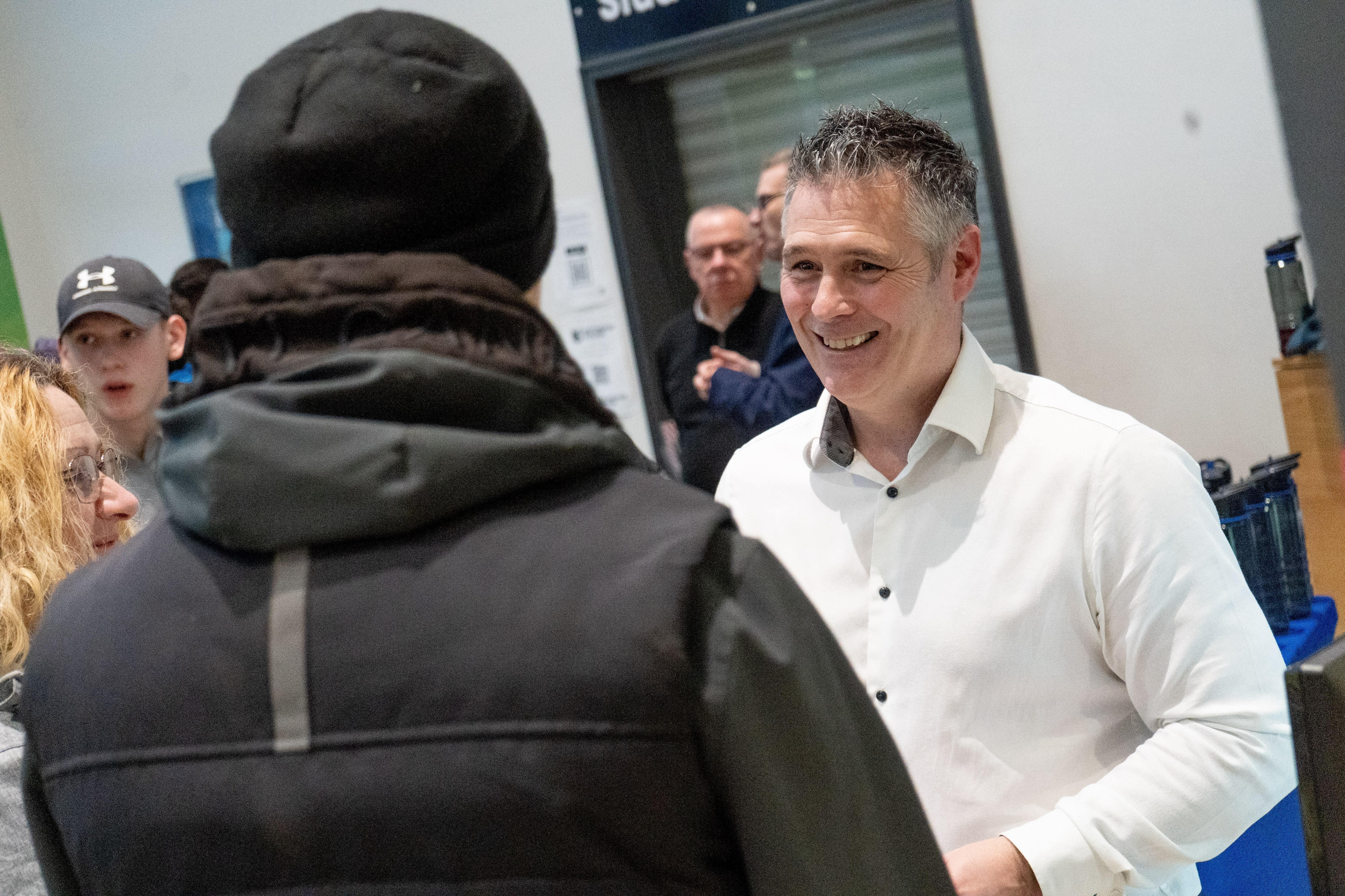 A student talking to a member of staff about apprenticeships at an open evening