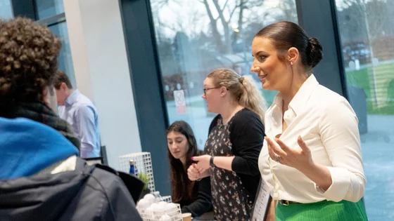 Members of staff speaking to students at an Open Evening