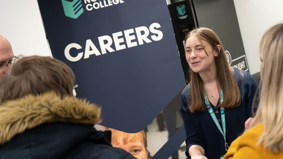 A member of staff giving careers advice at an Open Evening