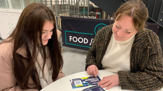 A lecturer and student talking in the canteen at the City Hub