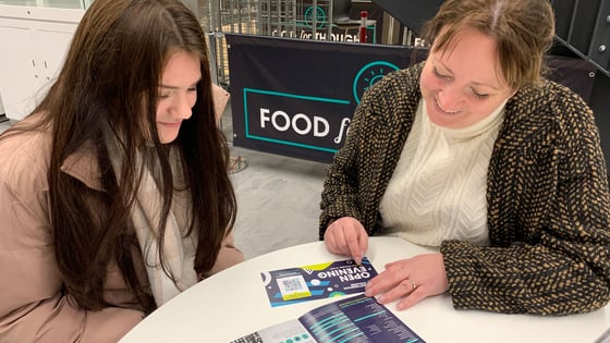 A lecturer and student talking in the canteen at the City Hub