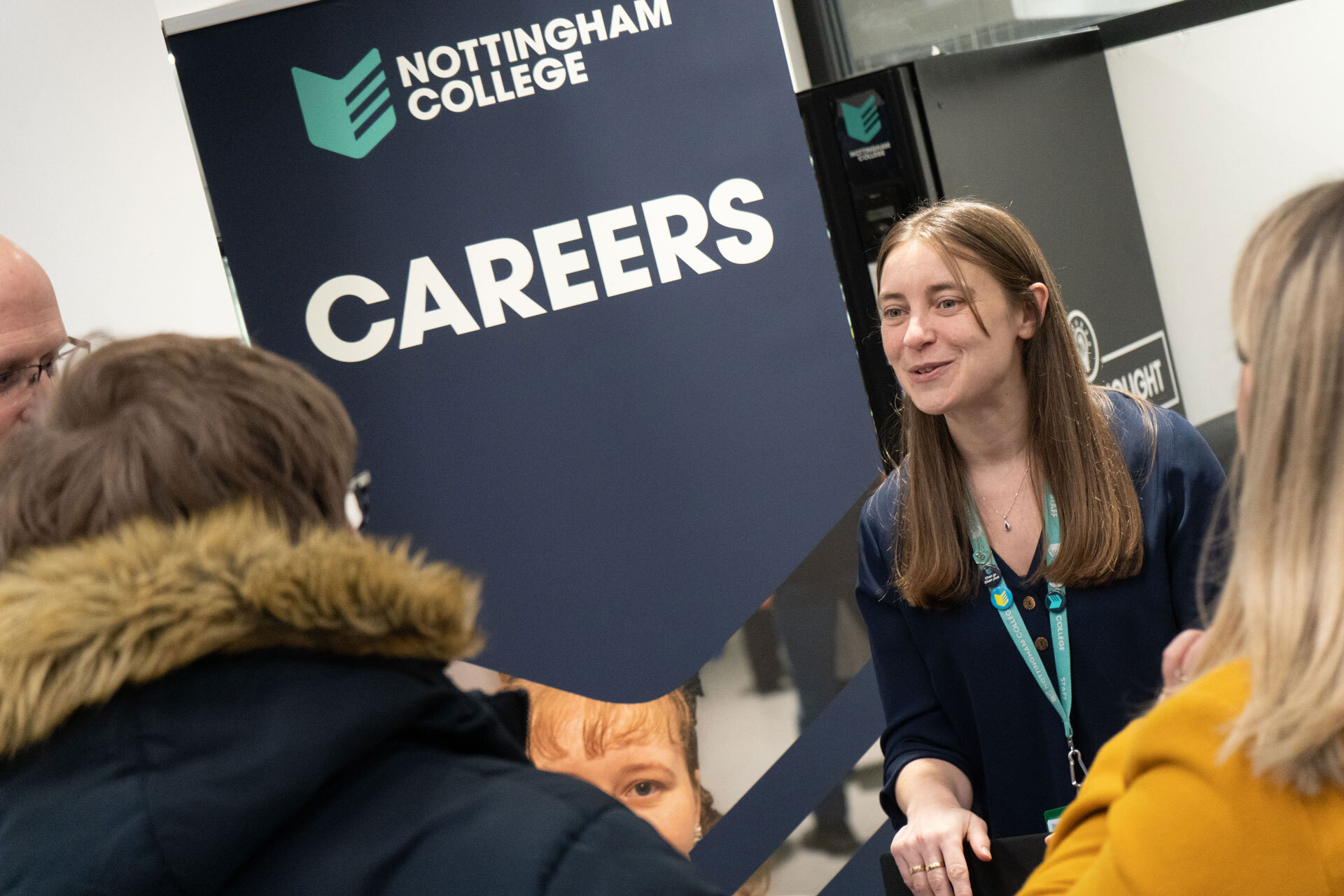 A careers team staff member talking to a group of people