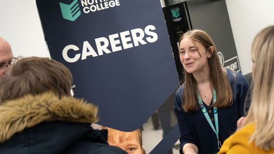 A careers team staff member talking to a group of people