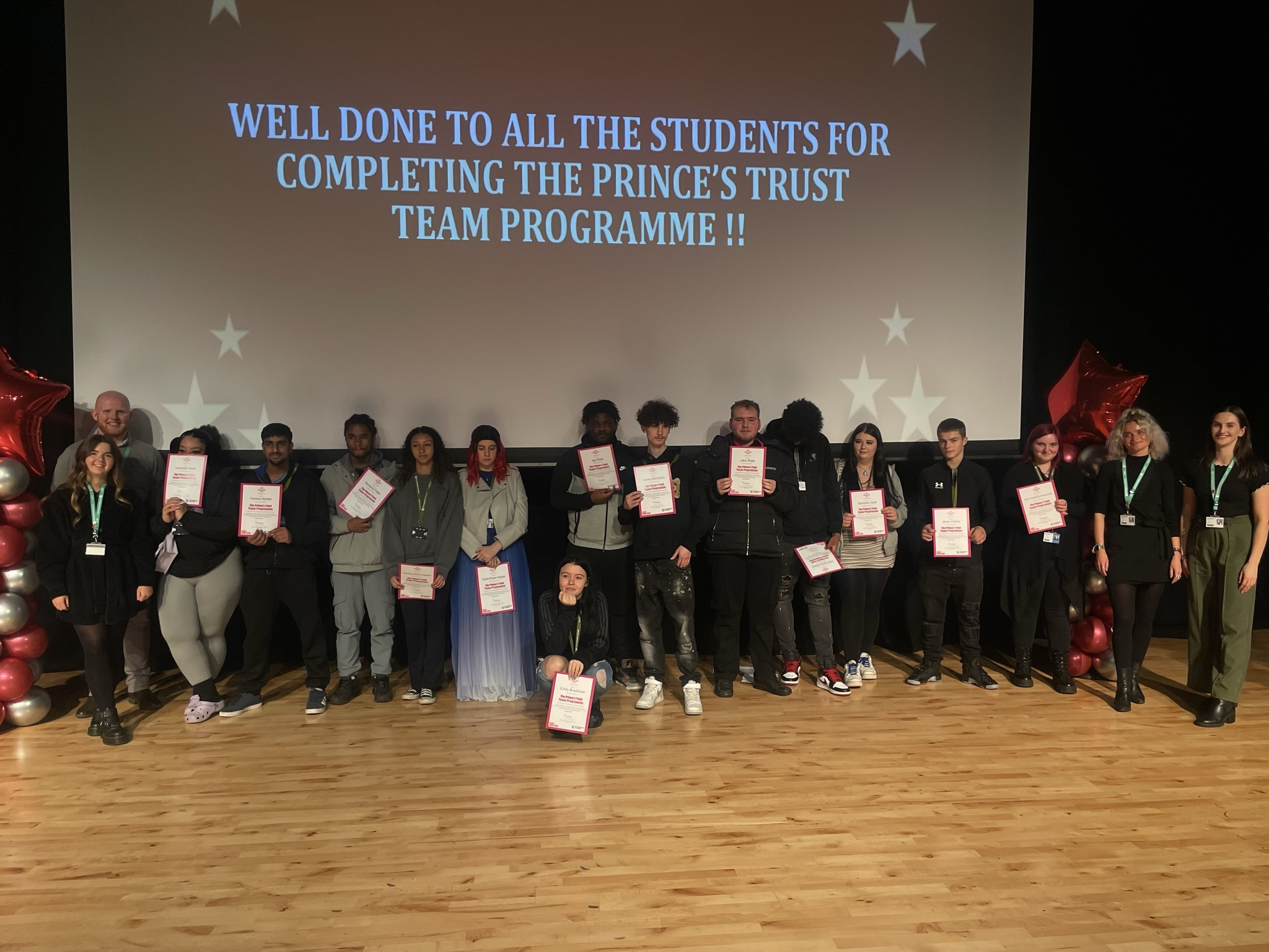Prince's Trust students in the theatre at the City Hub holding their certificates.