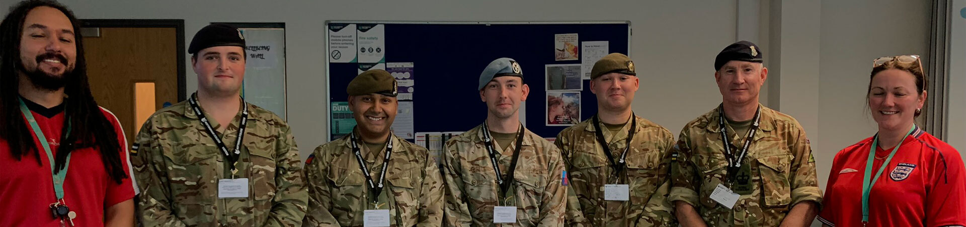 Public service students in army uniform with staff.