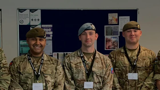 Public service students in army uniform with staff.