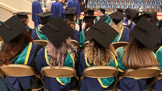 A picture of some graduates at a graduation ceremony in their gowns