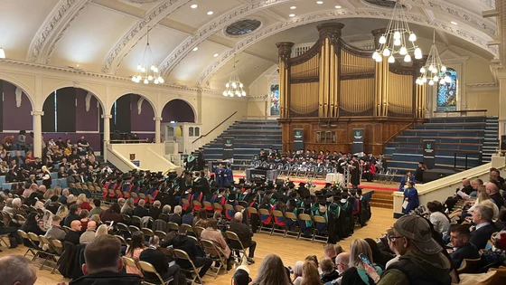 A picture of all of the attendees at a HE graduation ceremony