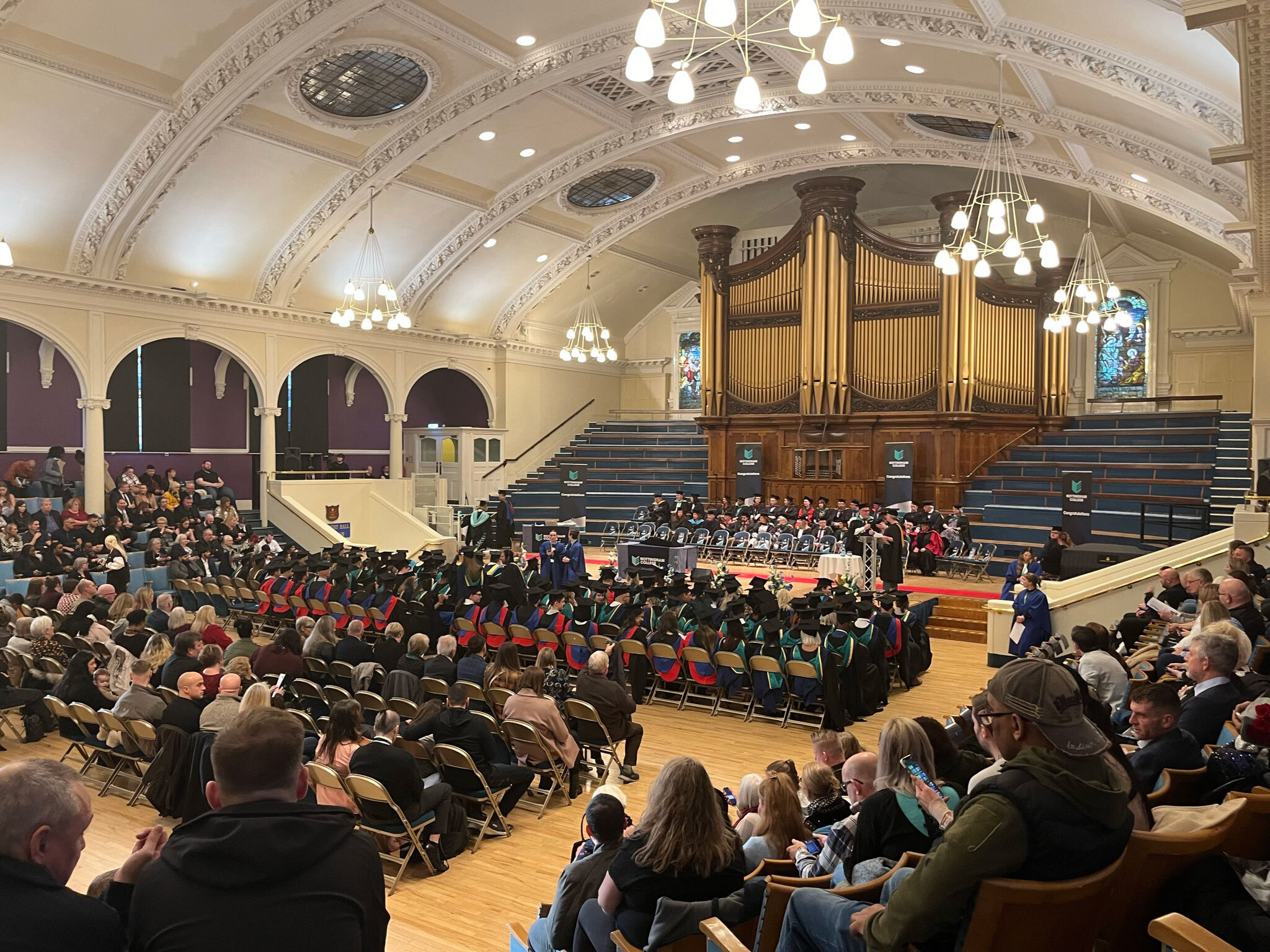 A picture of all of the attendees at a HE graduation ceremony