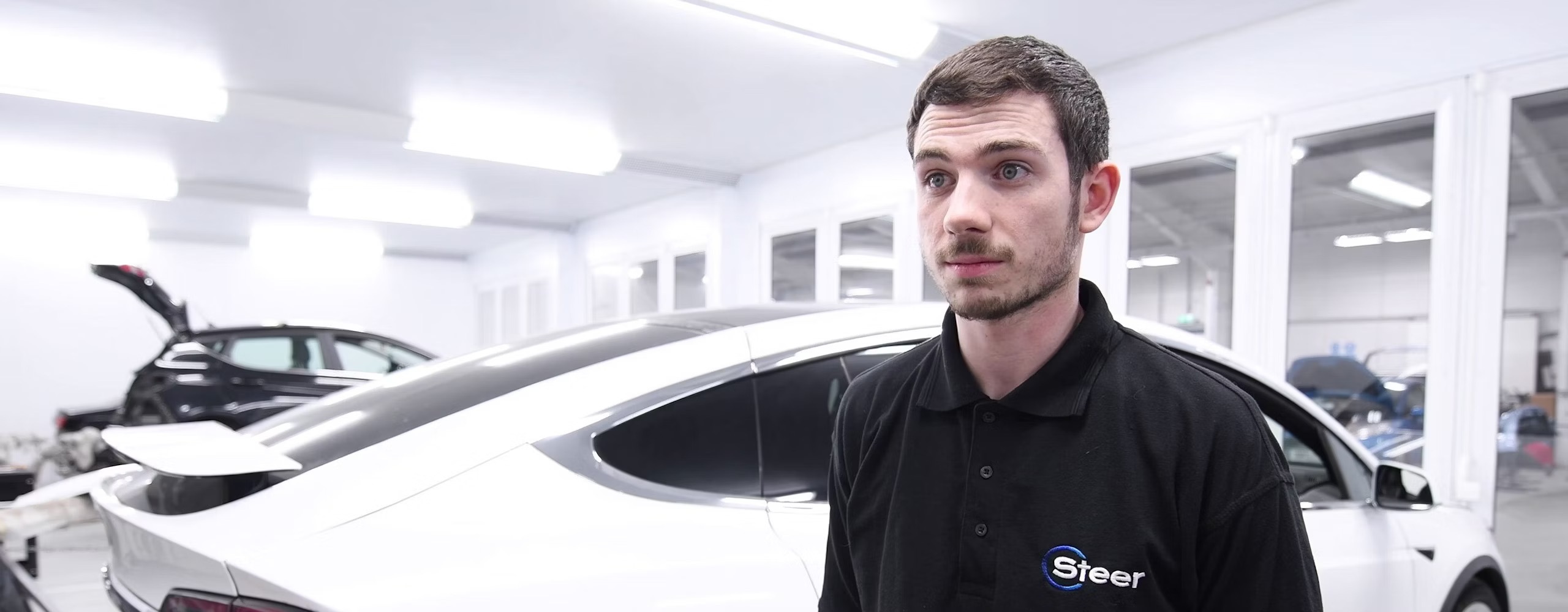 A Steer Automotive apprenticeship being interviewed inside a workshop
