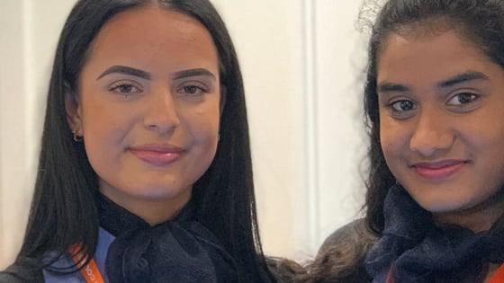 Two students in travel and tourism uniform in the aircraft cabin at the City Hub