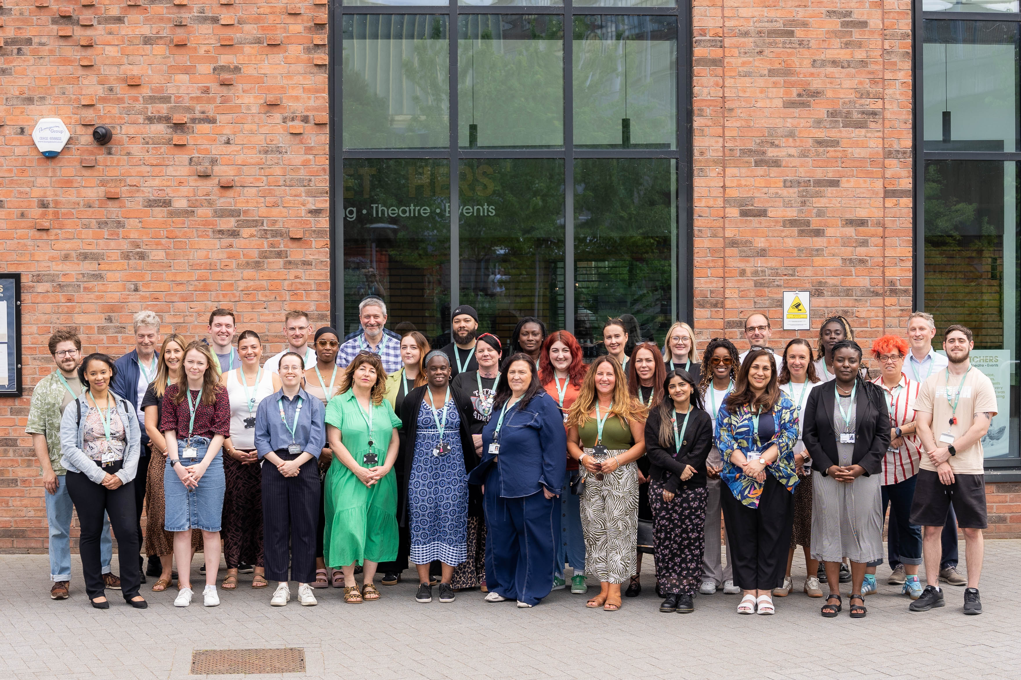 Members of the Personal Development Team smiling in front of our City Hub campus