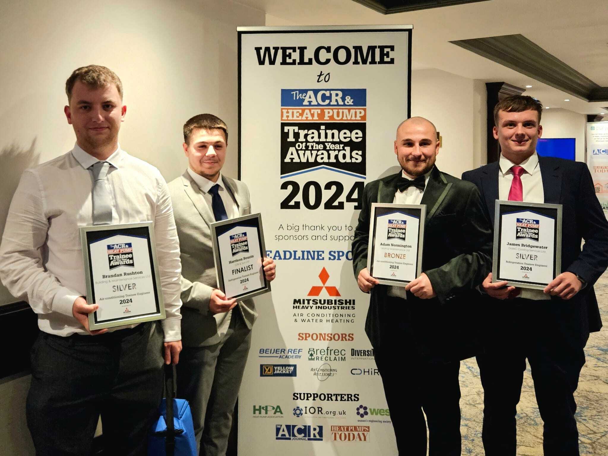 Brandan, Harrison, Adam and James (from left to right) smiling with their awards.