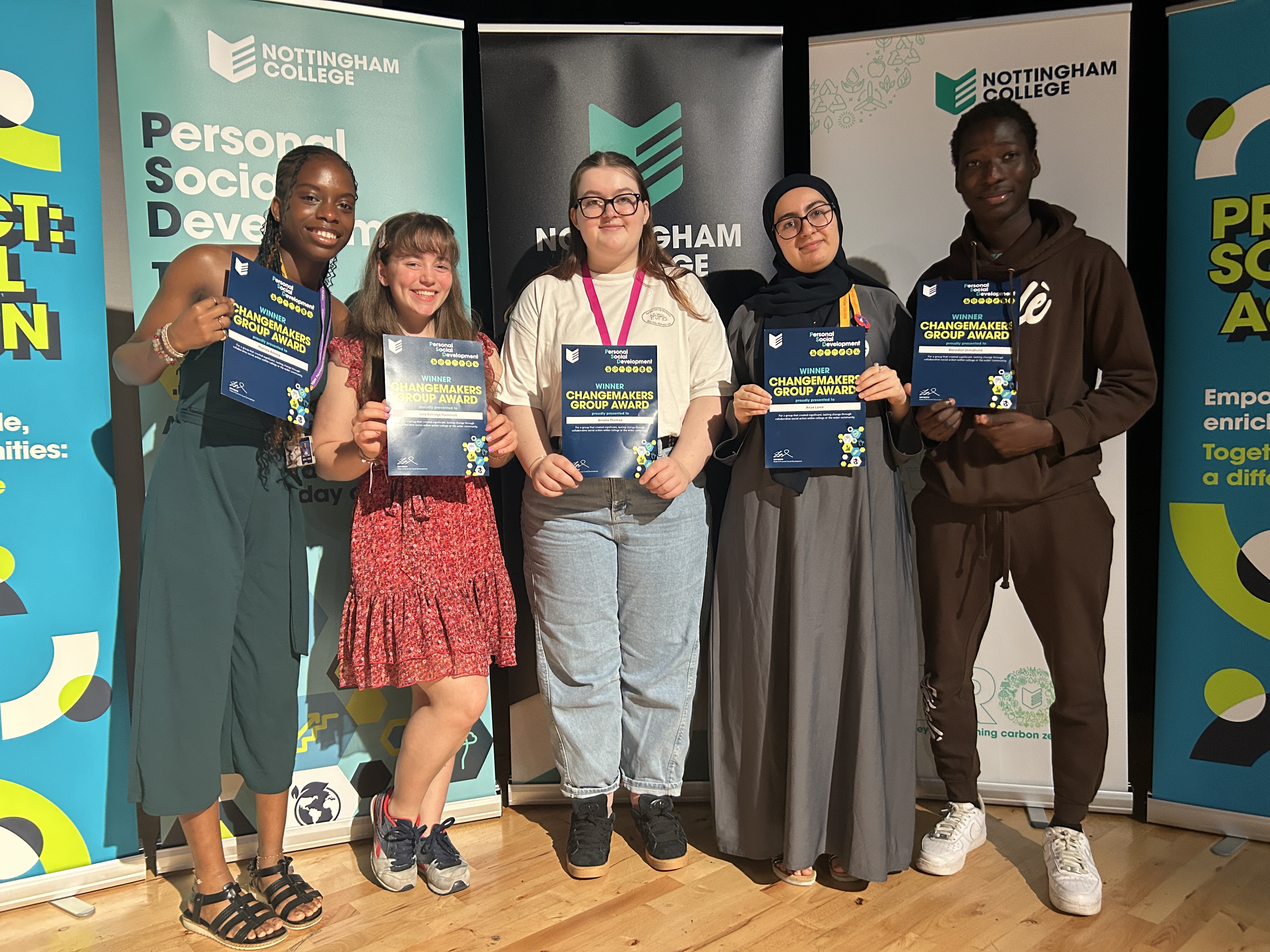 Student group photo with Personal Social Development certificates.