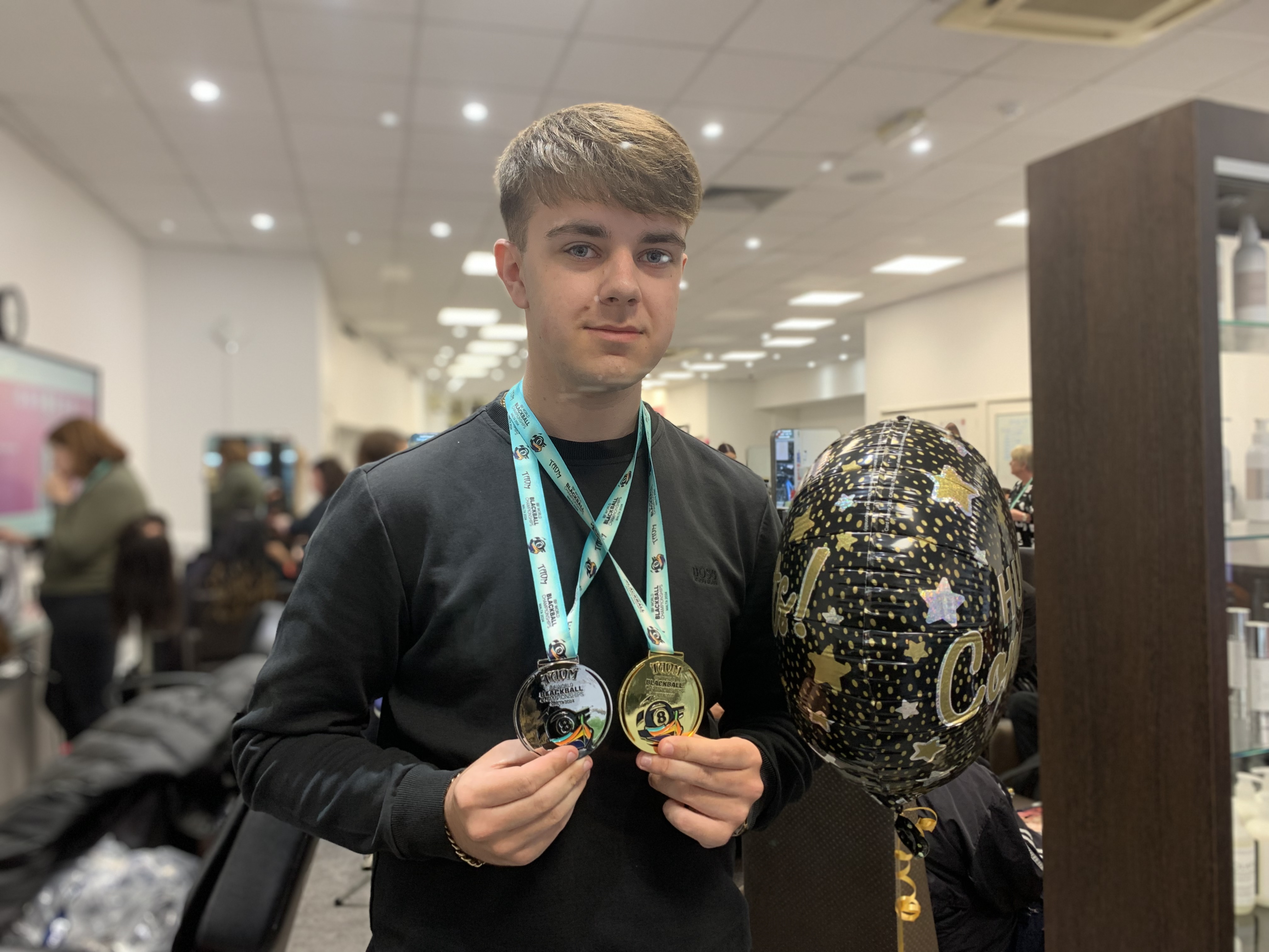 Ollie smiling with his silver and gold medals.