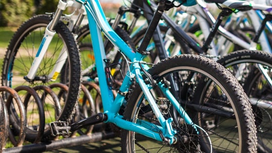 A row of bikes in a bike rack.
