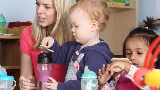A group of children playing with a member of staff.
