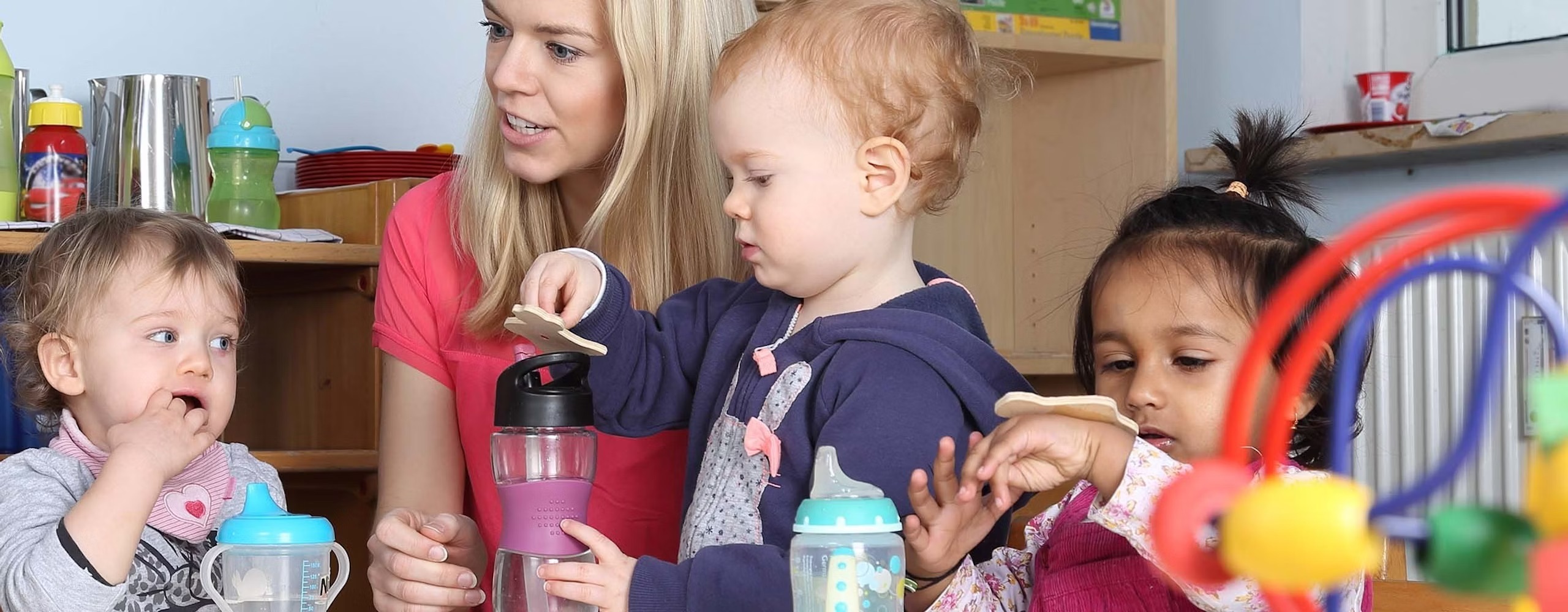 A group of children playing with a member of staff.