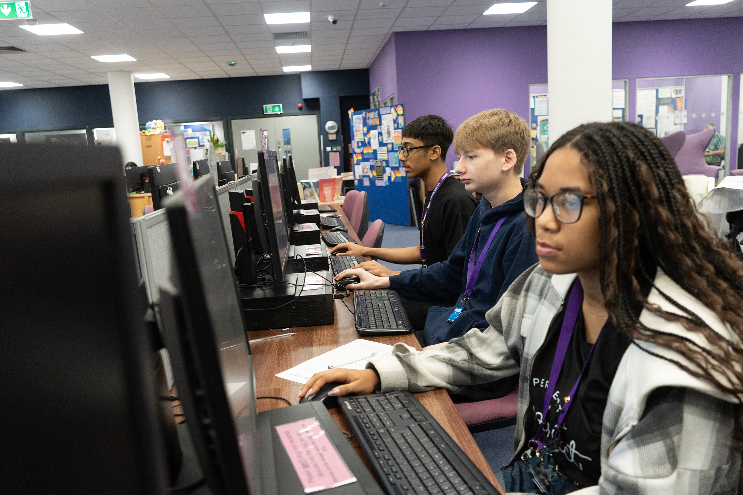 Students using computer workstations in the library