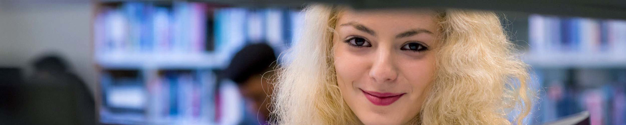 A smiling student in the library