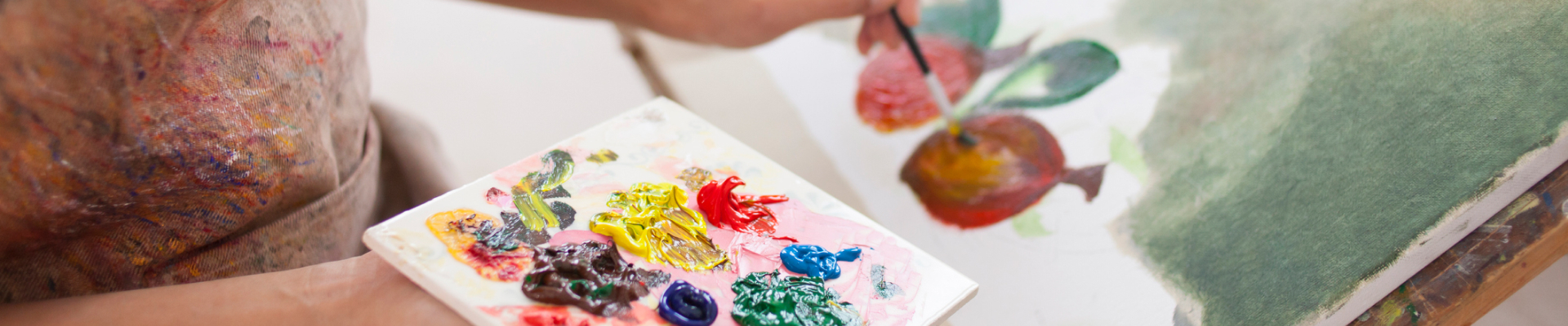 A student using a palette painting a picture