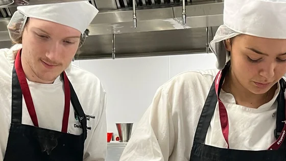 Two students working in our professional training kitchen at the City Hub
