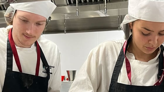 Two students working in our professional training kitchen at the City Hub