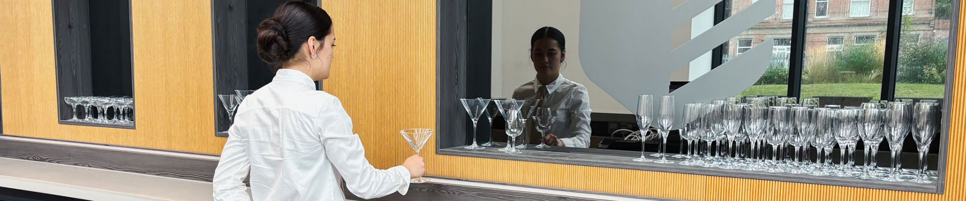 A student at the bar in Fletchers restaurant in the City Hub.