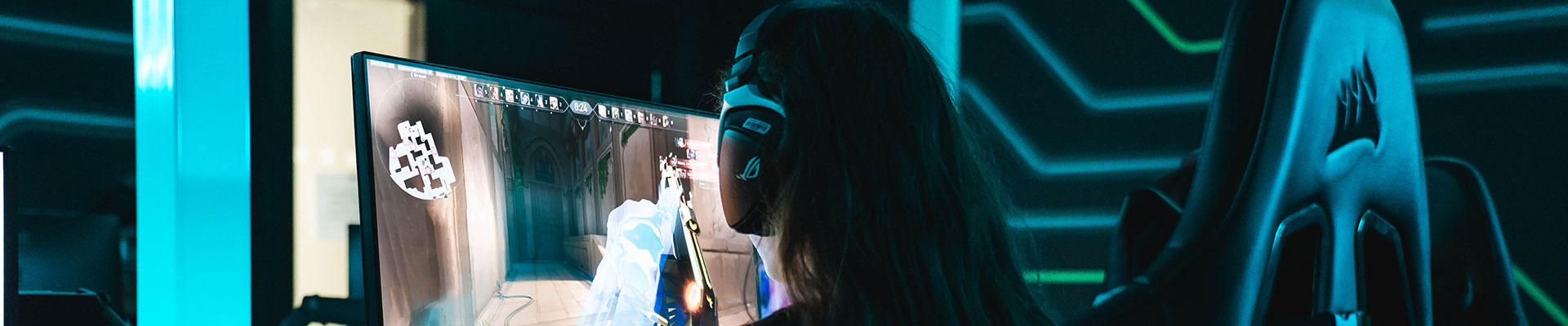 A female student sitting at a desk developing a video game in our state of the art esports classroom.