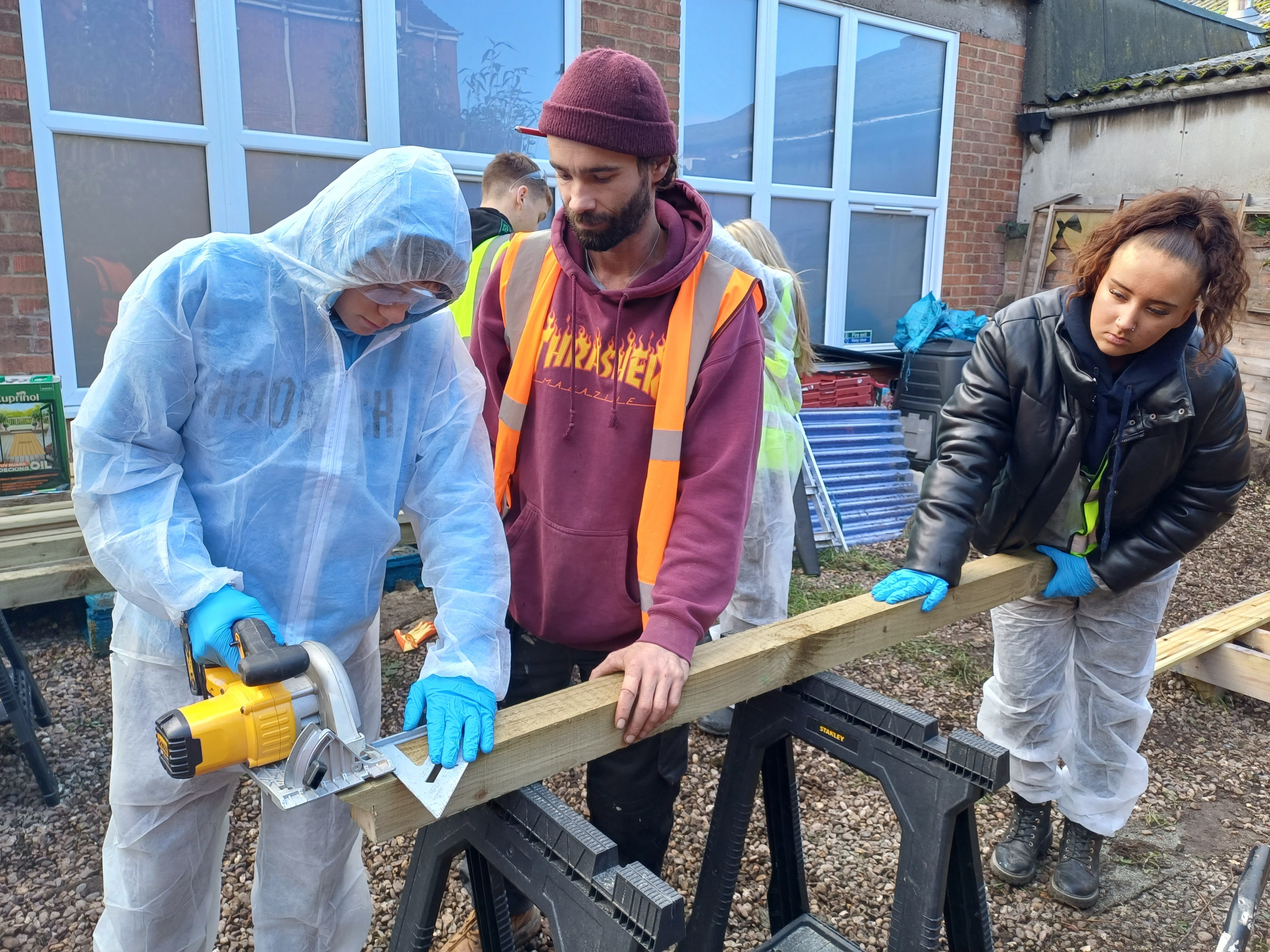 Students sawing wood