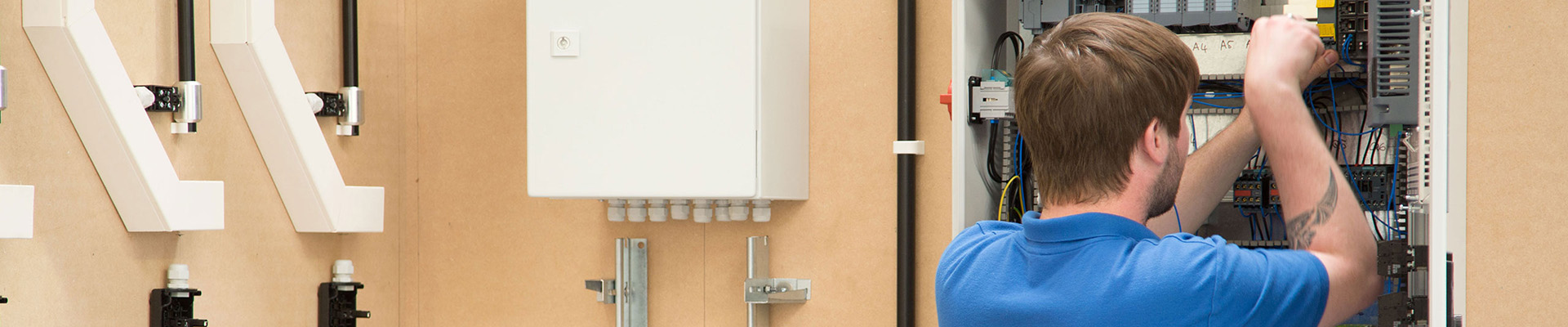 A student fixing a consumer unit