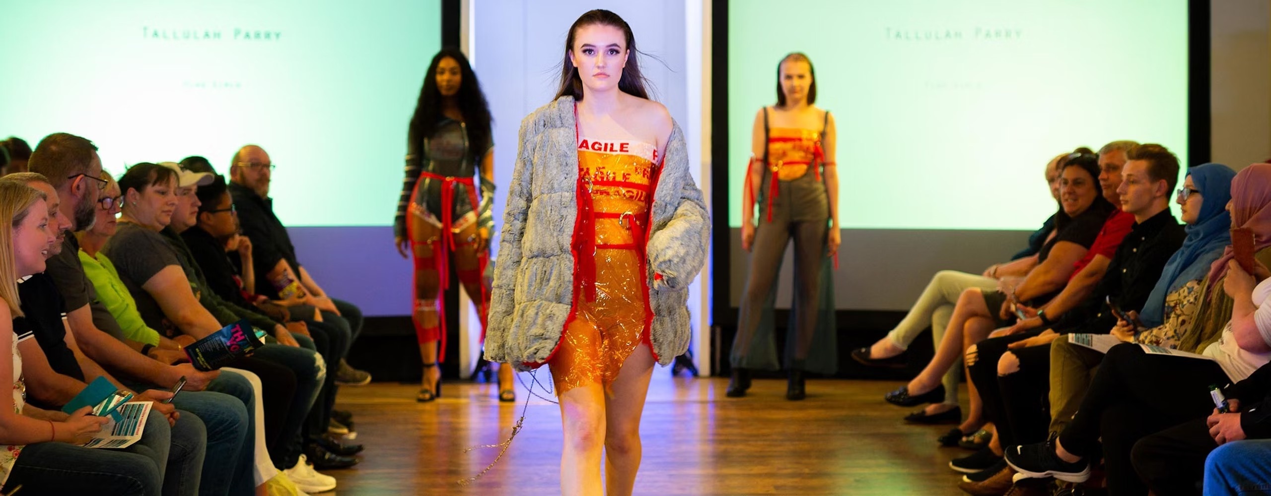 Fashion student at a fashion catwalk event showcasing their design