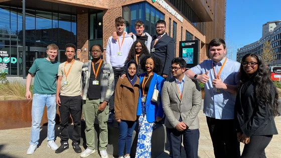 A large group of students stood together outside of the City Hub campus