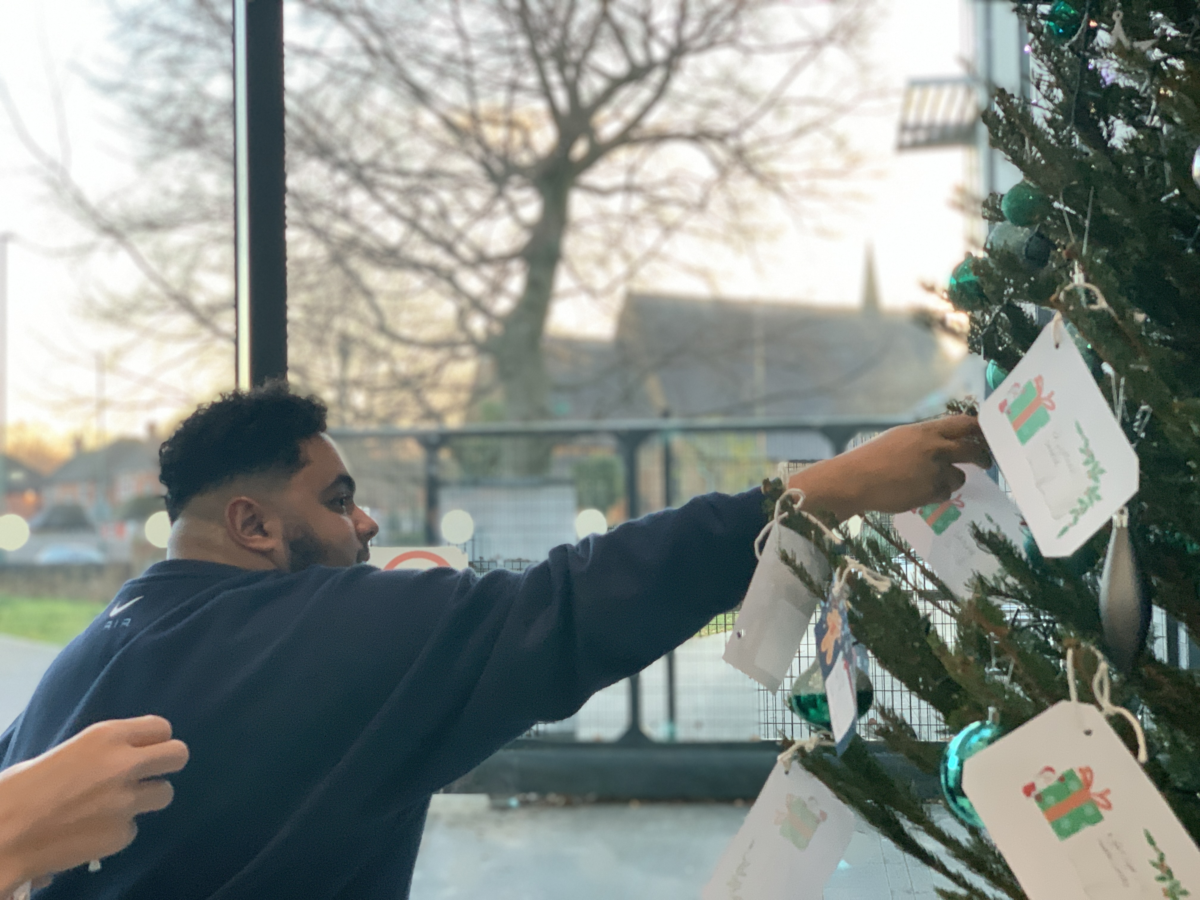 A student putting a message on the Positivi-tree
