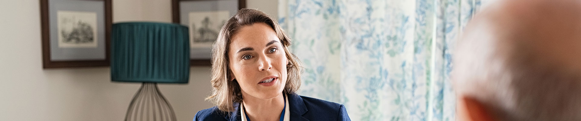 A care worker talking to an elderly person in a care home