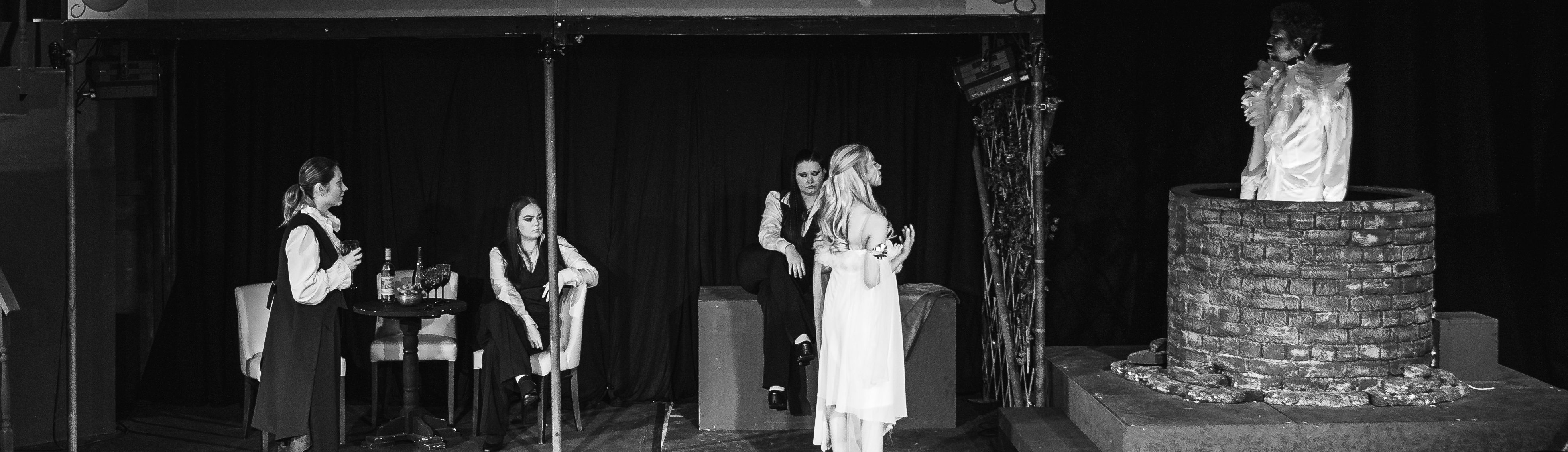 5 performing arts students acting on stage for a show in the theatre