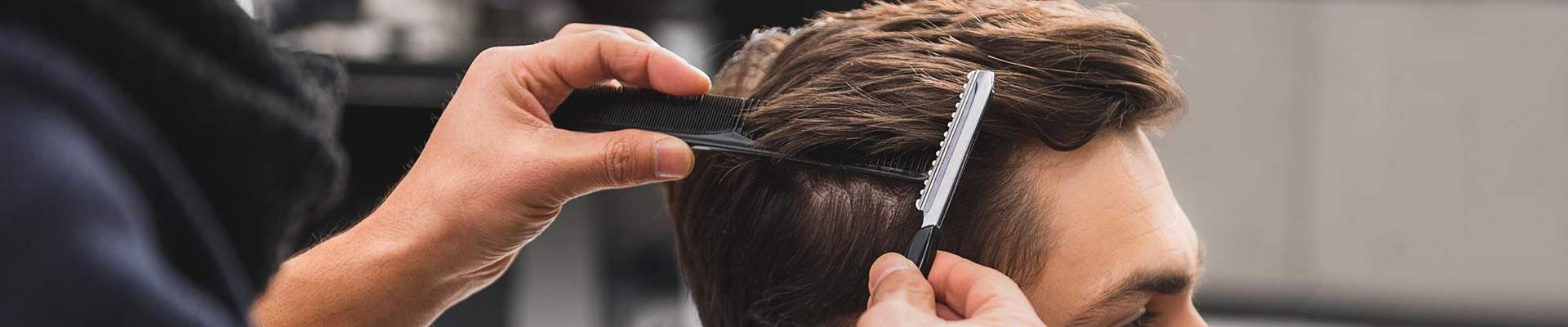 A student cutting a client's hair.