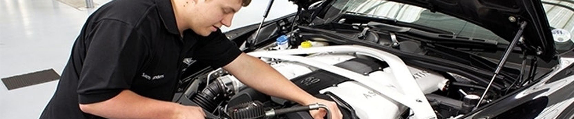 A student working on a car engine