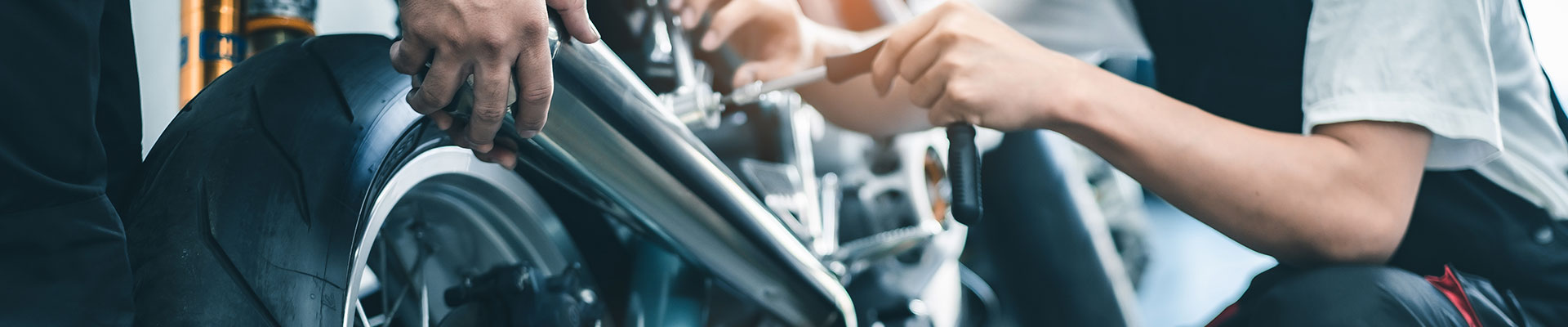 Two students working on a motorbike