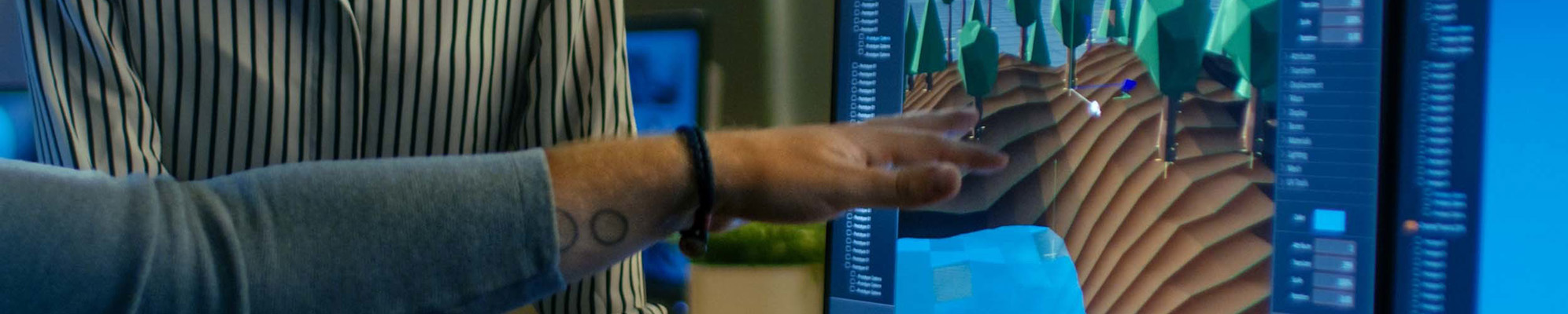 A student pointing at a computer screen