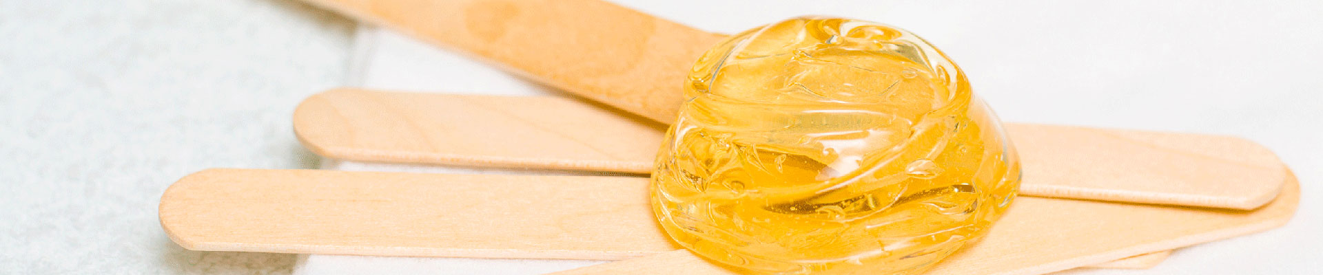 Waxing spatulas with a blob of wax.